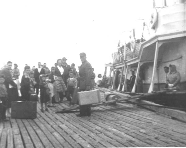 262: The steamer has arrived. Ernest Ryan (left, front), Joan (Barry) Ryan (left, behind  Ernie), Aloysius Ryan (dark clothes, right of Joan), Michael Patrick Norman (back,  fedora hat), Mike Carroll (center, suitcase). (1961) [courtesy of Rita (Ennis) Clowe]  - Joan daughter of Thomas Barry &amp;amp; Catherine Corrigan, mother of Ernest and  and Aloysius; Michael son of Thomas Norman &amp;amp; Jane Traverse; Michael son of  John Carroll &amp;amp; Eliz Reddy